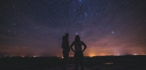 silhouette of people under milky way